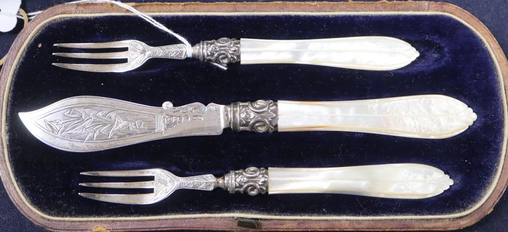 A silver and mother of pearl-handled three-piece butter/pickle set, Birmingham 1864, maker George Unite, cased